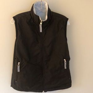 Reversible light blue fleece and black windbreaker material vest